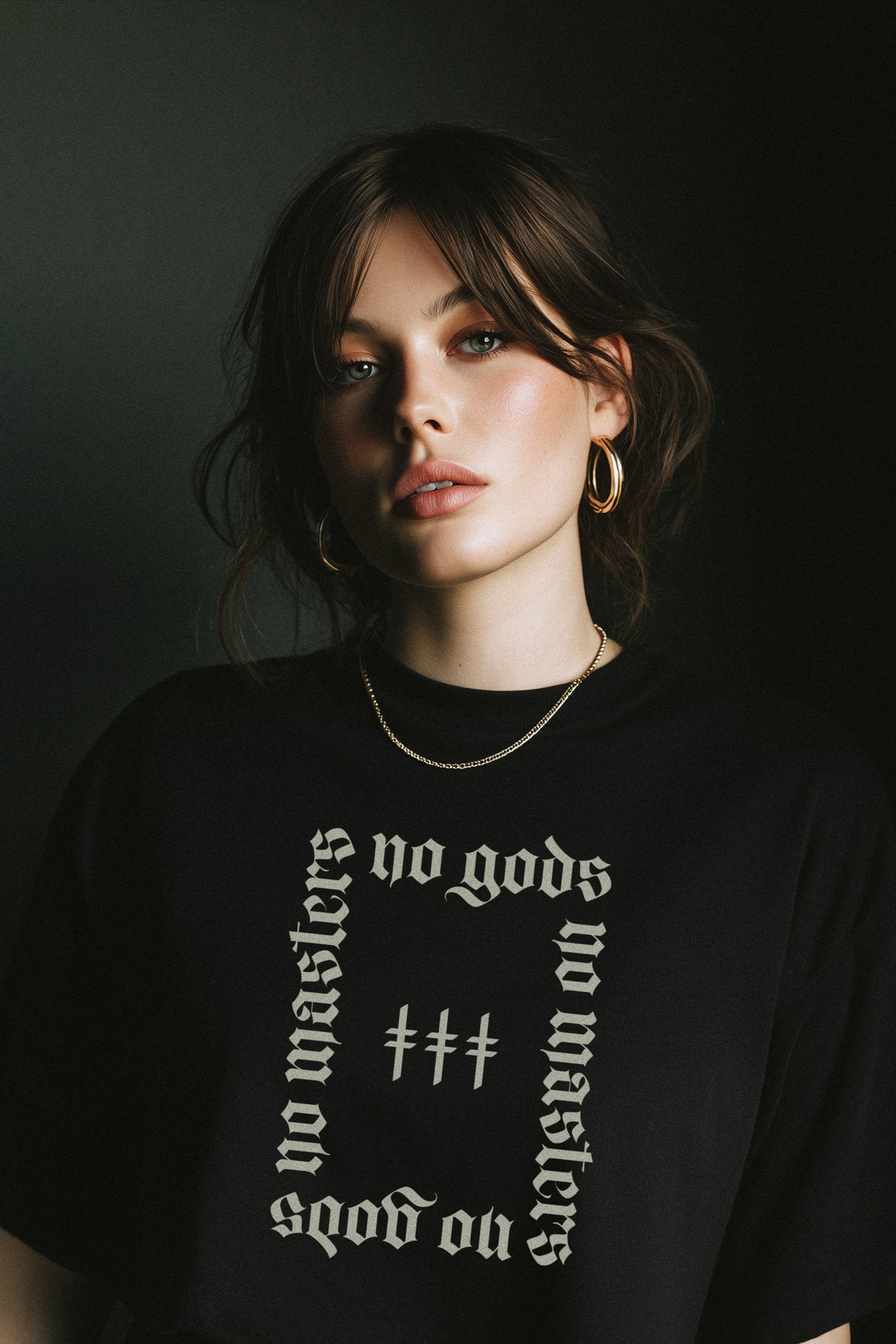 Woman wearing a black t-shirt with white text against a dark background