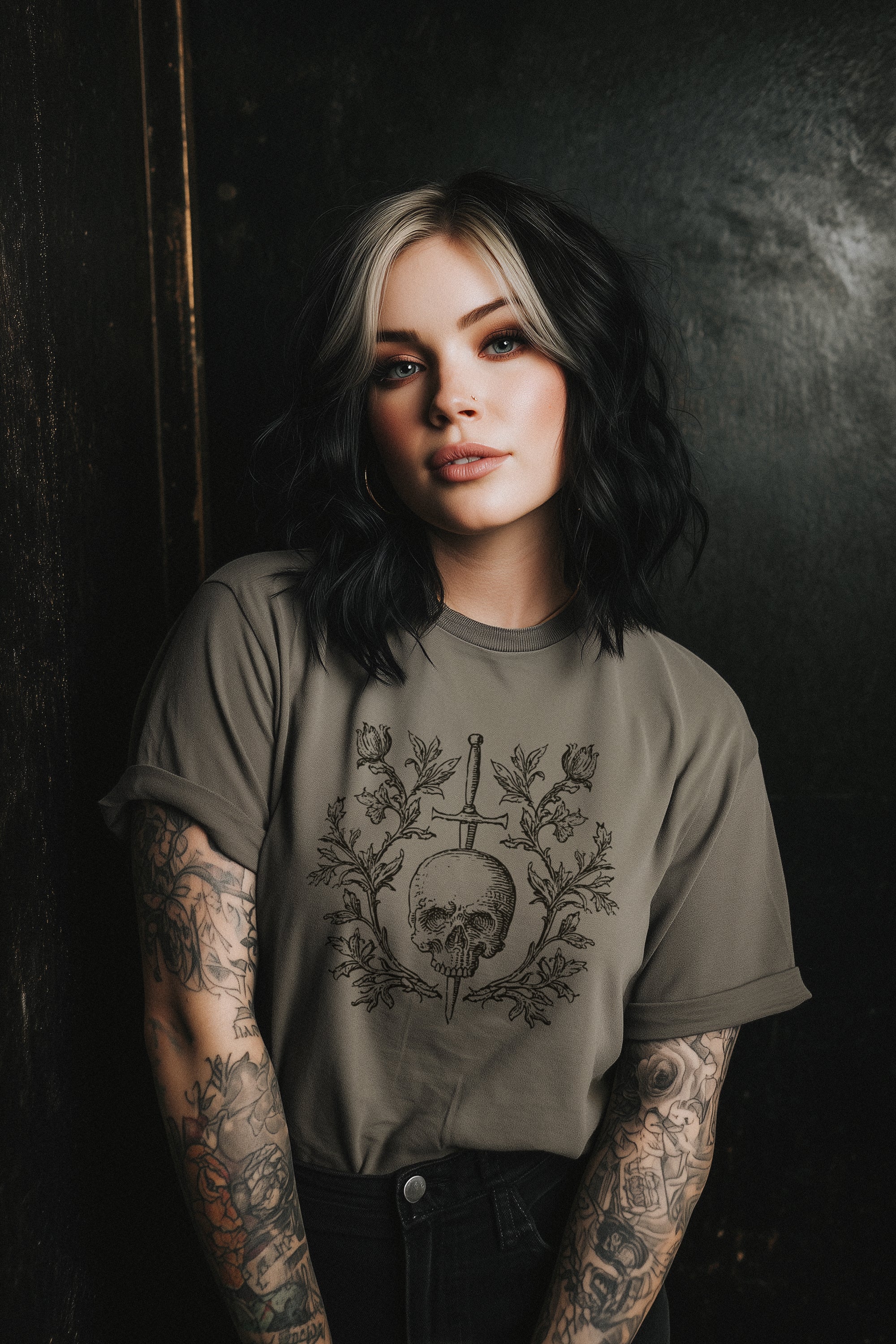 Person wearing a t-shirt with a skull design against a dark background